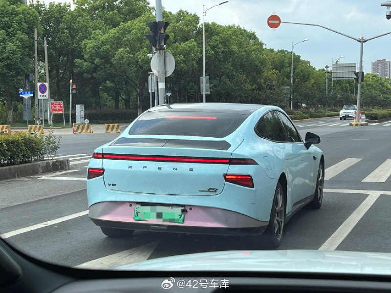 路上偶遇一台改装风的小鹏 P7，改色膜、轮圈这些都是常规操作，最厉害的还是车尾这个尾翼，看着像是可升降的，这不得切尾厢盖？配图